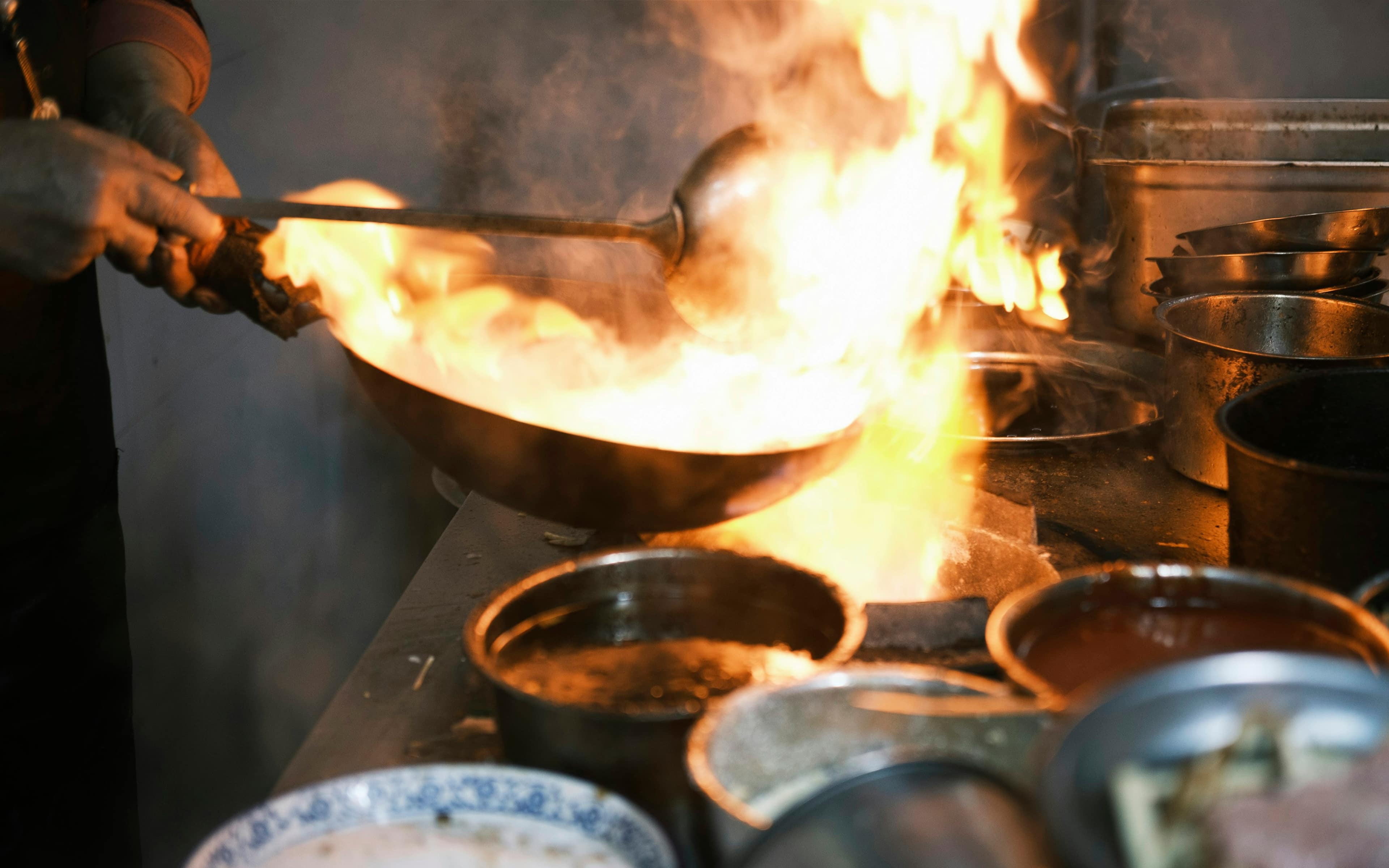 A karahi dish being prepared for a catered event